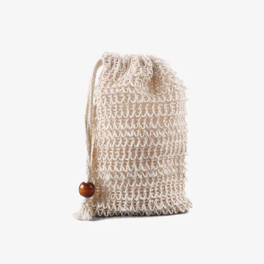 Knitted drawstring soap saver bag with a wooden button on a white background